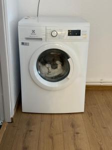 a white washing machine sitting in a room at TwinNest Petrila in Petrila