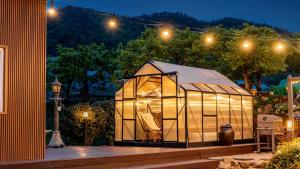a large tent in a garden at night at Yeosu Elon Pension in Yeosu