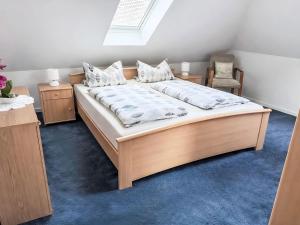 a bedroom with a large bed and a chair at Apartment Marianne by Interhome in Hooksiel