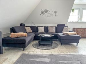 a living room with a blue couch and a table at Apartment Marianne by Interhome in Hooksiel