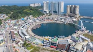 an aerial view of a city with a harbor at Sokcho Maru Pension in Sokcho