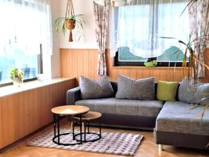 a living room with a couch and a table at Holiday Home Katharina by Interhome in Gröbming