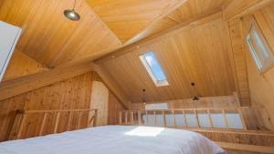 a bedroom in a wooden cabin with a bed at Yeongheungdo Rainbow Ocean View Pension in Incheon