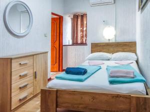 a bedroom with a bed with blue towels on it at Holiday Home Delfar by Interhome in Nerezine