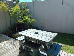 a wooden picnic table with a ball on top of it at Two Oceans Stay in Cape Town