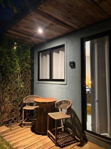 a patio with a table and chairs on a deck at Oby Noronha in Fernando de Noronha +20 photos