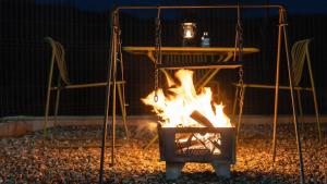 a fire burns in front of a table at Yangyang Lira Camp in Yangyang