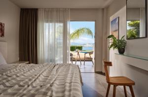 a bedroom with a bed and a view of the ocean at Ionian Hill Hotel in Argassi +48 photos