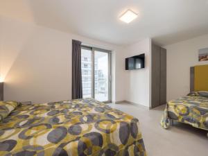 a bedroom with two beds and a window at Apartment Nashira-4 by Interhome in Lignano Sabbiadoro