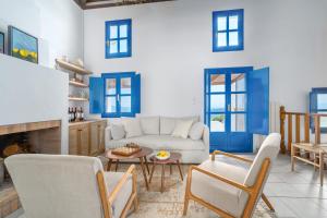 a living room with a white couch and blue walls at Villa Cleio where the sea meets absolute calm in Skiathos