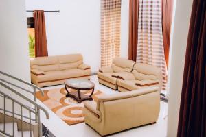 a living room with two chairs and a table at Stella nova motel in Kigali
