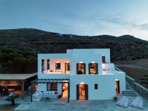 a white house with a hill in the background at Seriphos Estate in Serifos Chora