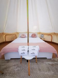 a bedroom with a bed in a tent at Epic Glamping in Călimăneşti +19 photos