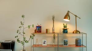 a shelf with a lamp and a plant on it at Sokcho Biroso Private Cottage in Sokcho +11 photos