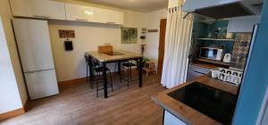 a small kitchen with a table and a counter top at Gite au Petit Verger in Masevaux