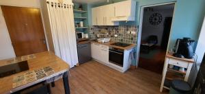 a kitchen with a sink and a stove top oven at Gite au Petit Verger in Masevaux +35 photos