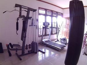 a gym with two tread machines and a window at 24/7 Bed & Breakfast in Jimbaran