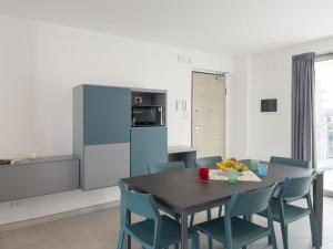 a kitchen and dining room with a table and chairs at Apartment Nashira-6 by Interhome in Lignano Sabbiadoro +12 photos