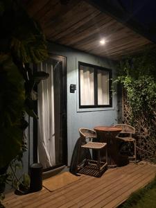 a patio with a table and chairs on a deck at Oby Noronha in Fernando de Noronha