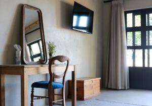 a chair sitting in front of a desk with a mirror at Rietfontein 1888 in De Aar