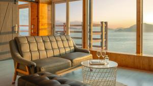 a living room with a couch and a table at Geoje Inbito Pension in Op'o