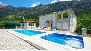 a swimming pool in front of a house at Vila Nova with private heating pool and jacuzzi in Zavojane