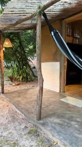 a hammock hanging from a porch of a building at Pouso do Cajueiro - Moreré in Cairu