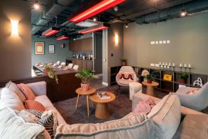 a salon with couches and chairs in a room at The Artisan - City Centre in Dublin