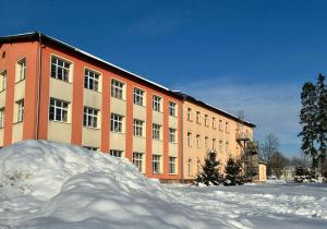 a pile of snow in front of a building at Self-Check Hostel Rico in Vrchlabí