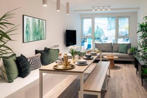 a living room with a table and a couch at The Artisan - City Centre in Dublin