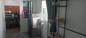 a kitchen with a refrigerator with fruit in a room at Wilfrid villa in Hua Hin