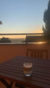 a cup of coffee sitting on top of a wooden table at Villa della Vita in Pécs