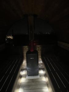 a bench in a dark room with lights on it at Villa della Vita in Pécs