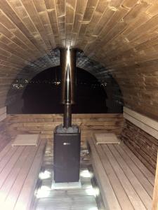 a small stove in a room with a tunnel at Villa della Vita in Pécs