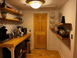 a kitchen with a wooden counter and a wooden door at Queen Anne's Revenge in Bar Harbor