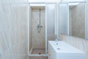 a bathroom with a shower and a sink and a mirror at Happyfew maison Michelet in Nice +10 photos