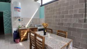 a kitchen with a table with chairs and a stove at La Casita de Junín in Junín