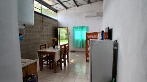 a kitchen and dining room with a refrigerator and a table at La Casita de Junín in Junín