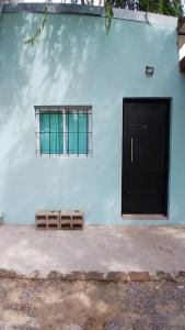 a blue building with a door and a window at La Casita de Junín in Junín