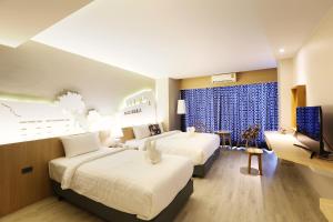 Postel nebo postele na pokoji v ubytování Hatyai Signature Hotel