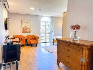 a living room with a couch and a dresser at Vila Pugliesi Hotel Boutique in Lençóis
