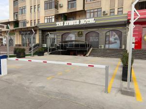a barrier in a parking lot in front of a building at The Avenue Hotel in Kogon
