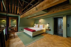 a bedroom with a large bed and a bathroom at Hotel 1635 in Haarlem