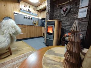 a living room with a table and a fireplace at Chata Adavy in Liptovský Ján