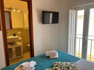 a bathroom with a bed and a sink and a mirror at Teatro Massimo - Apartment with a View of Theater Massimo in Palermo +18 photos