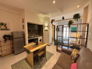 a living room with a couch and a table at Teatro Massimo - Apartment with a View of Theater Massimo in Palermo