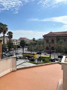 a view of a city with buses in a parking lot at Teatro Massimo - Apartment with a View of Theater Massimo in Palermo
