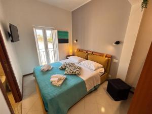 a bedroom with a bed with towels on it at Teatro Massimo - Apartment with a View of Theater Massimo in Palermo