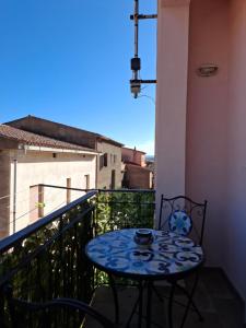 a small table on a balcony with a view at Da Ghjuannedda in Arzachena