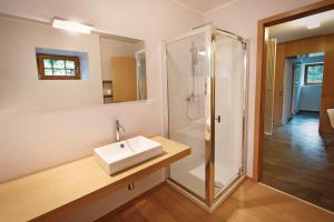 a bathroom with a sink and a shower at Albergo Diffuso Tolmezzo in Tolmezzo +51 photos